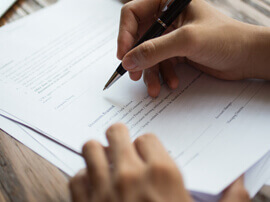 Close up of person filling out a billing form.