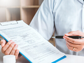 Close up of person filling out an insurance form.