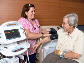 Therapist taking a patient's blood pressure reading.