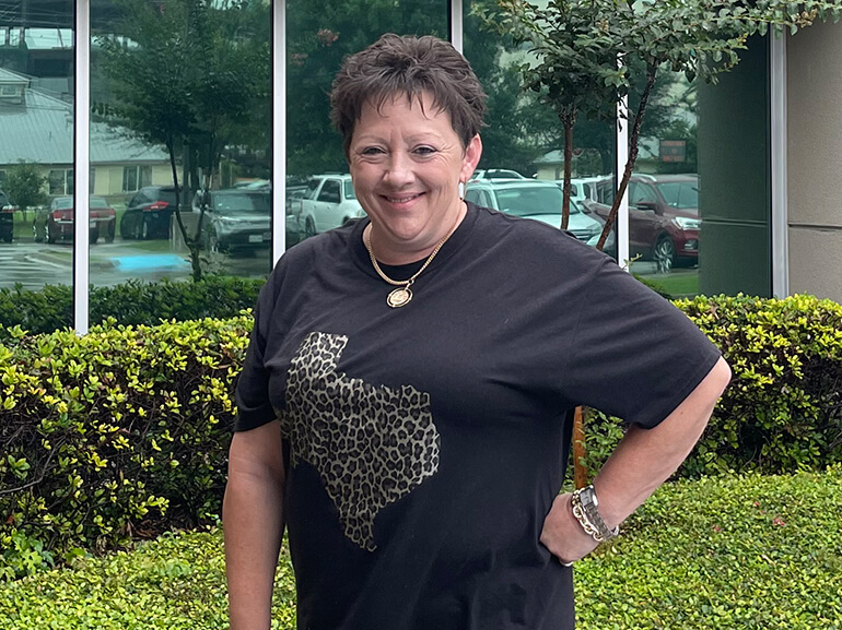 Rhonda King standing in front of Select Rehabilitation of Denton after her discharge.