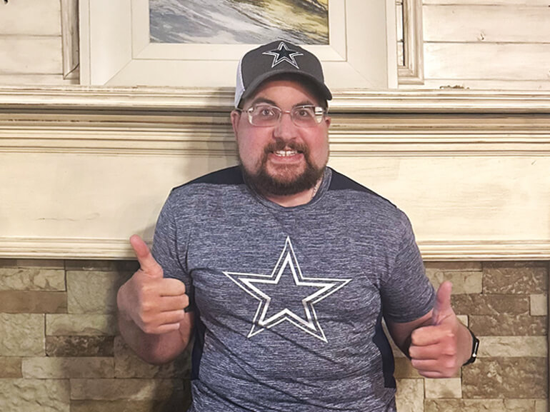 Graham Autry gives two thumbs up after rehabilitation.