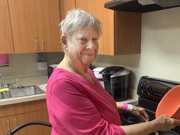 Louise Riggs participates in therapy in the hospital's kitchen suite.
