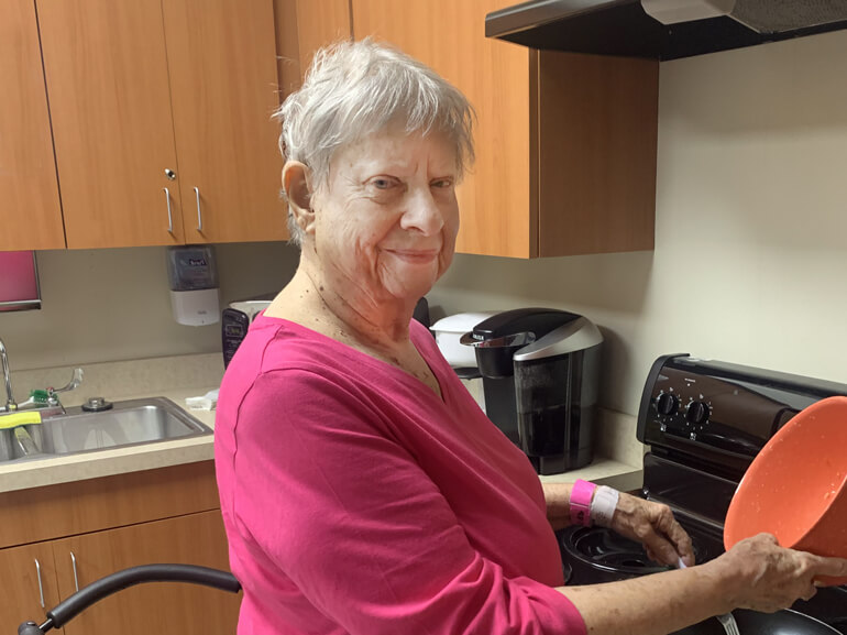 Louise Riggs participates in therapy in the hospital's kitchen suite.