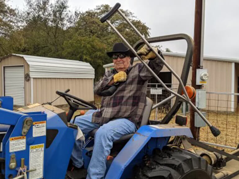 Richard Andrews drives his tractor following rehabilitation.