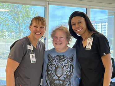 Susan Kirschner smiles with two of her therapists.