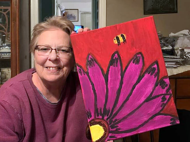 Vicki Tennison displays her art from recreational therapy.